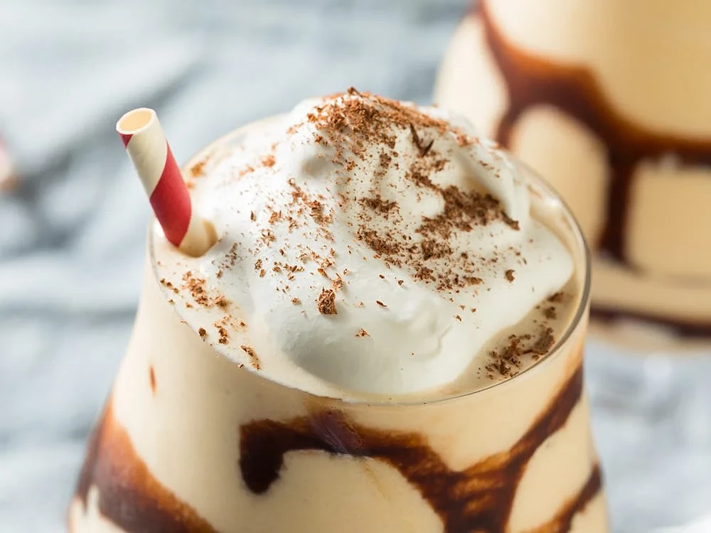 Dirty monkey drink with whipped cream and chocolate syrup on the top.