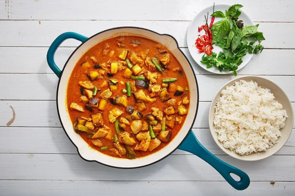 Thai curry in a saucepan along with white rice