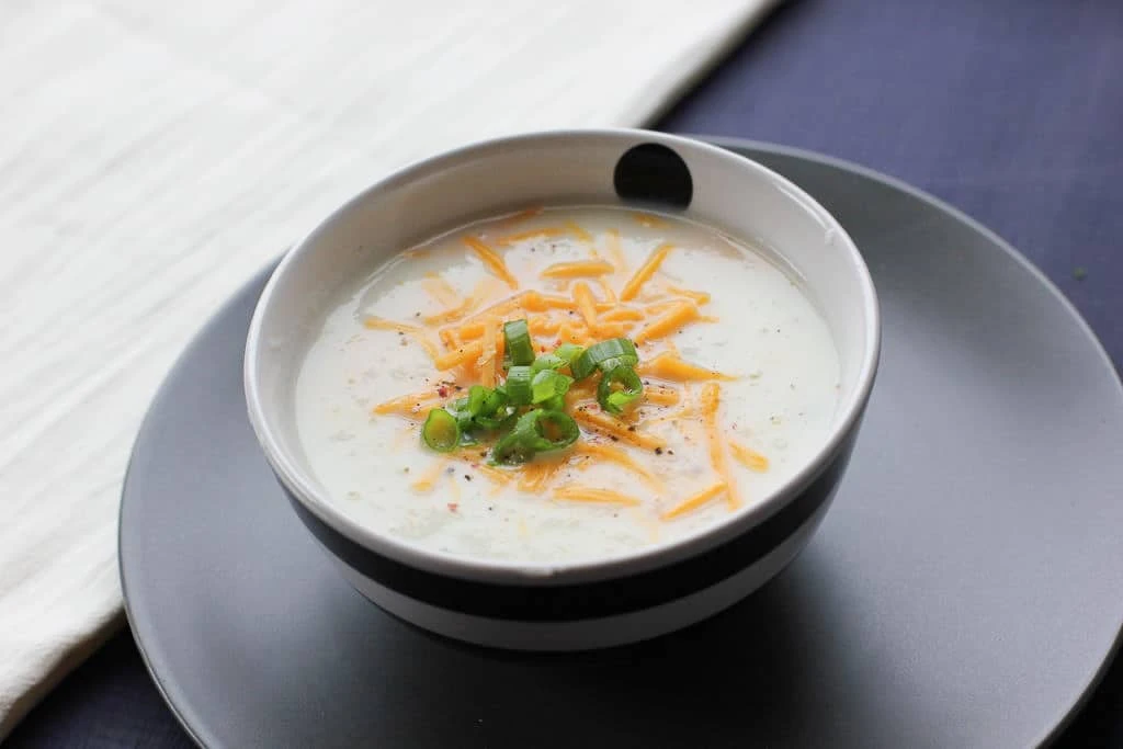 Cheddar cheese on the top of the soup.