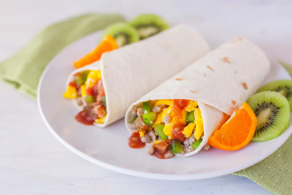 mc'donald's breakfast burrito in a plate with fruits