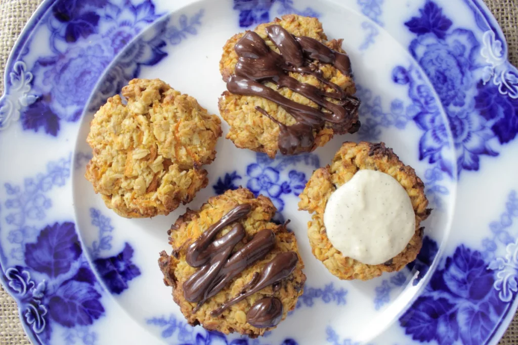 carrot cake macaroons topped with chocolate and one with icing
