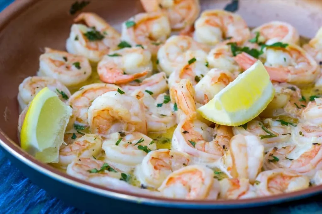 Shrimp scampi with lemon wedges
