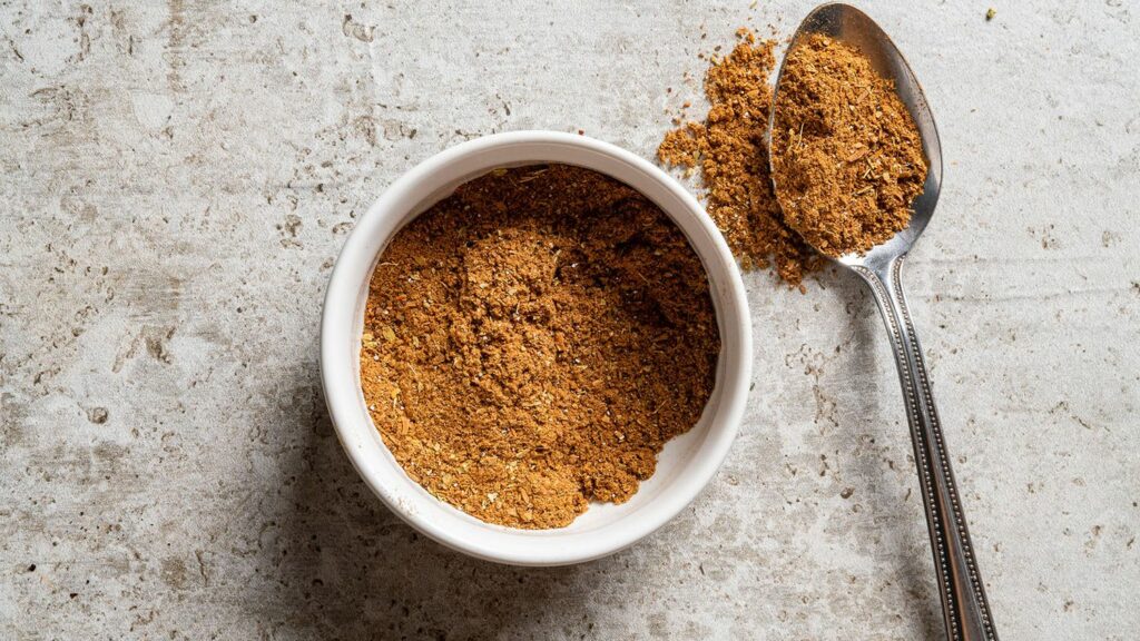 House Seasoning In White Bowl With Spoon