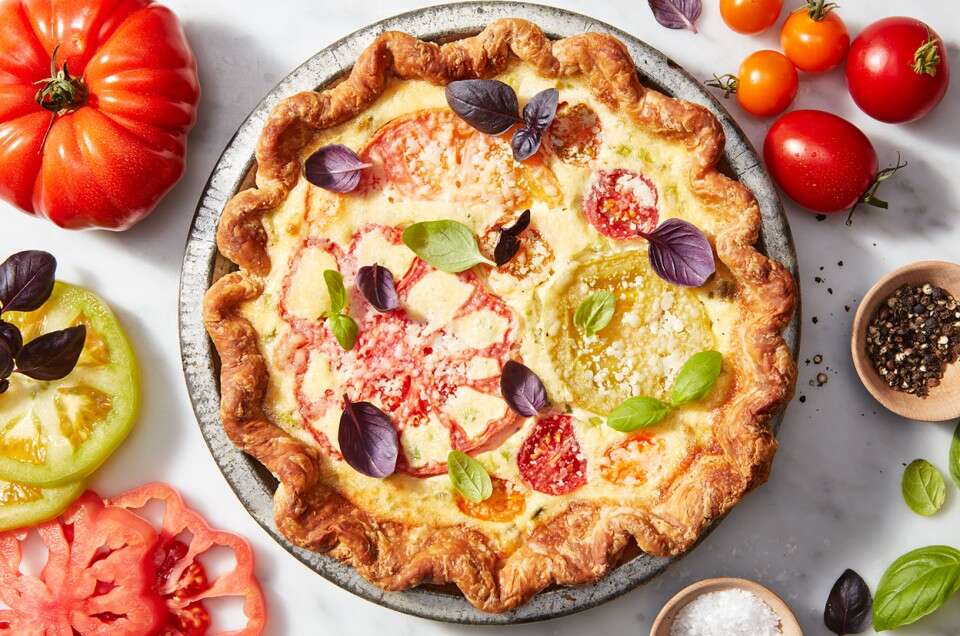 Tomato Pie In Pie Dish Garnished With Veggies