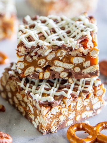 Chocolate Caramel Pretzel Bars stacked on top of each other.