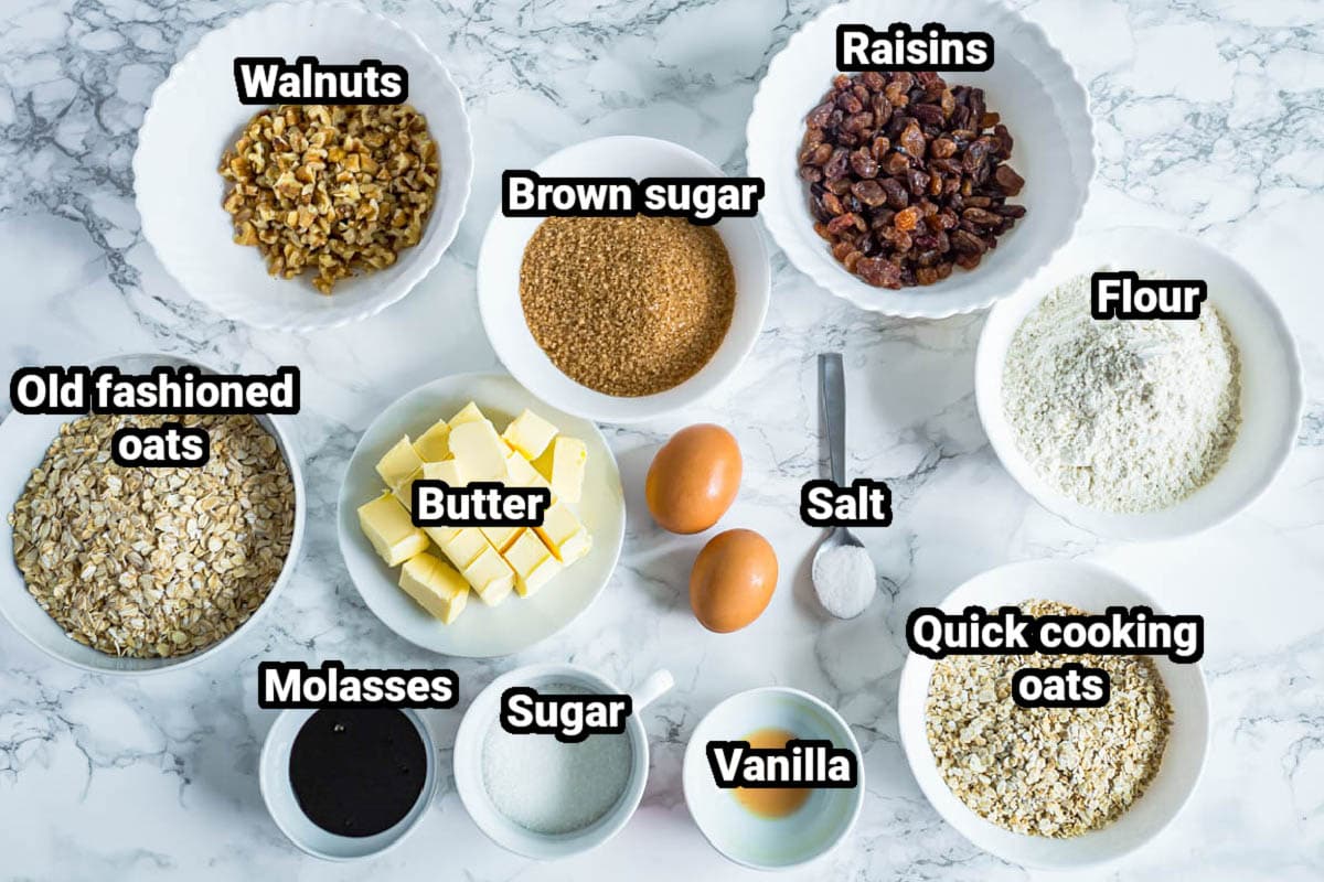Ingredients for Chewy Oatmeal Raisin Cookies: oats, flour, butter, brown sugar, molasses, sugar, vanilla, salt, eggs, walnuts, and raisins.