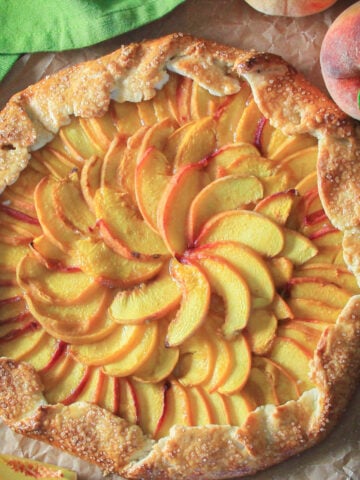 Overhead view of Peach Galette with peaches nearby