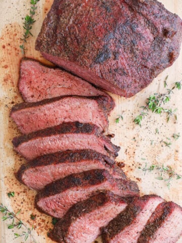 Smoked Tri Tip on a cutting board and half sliced.