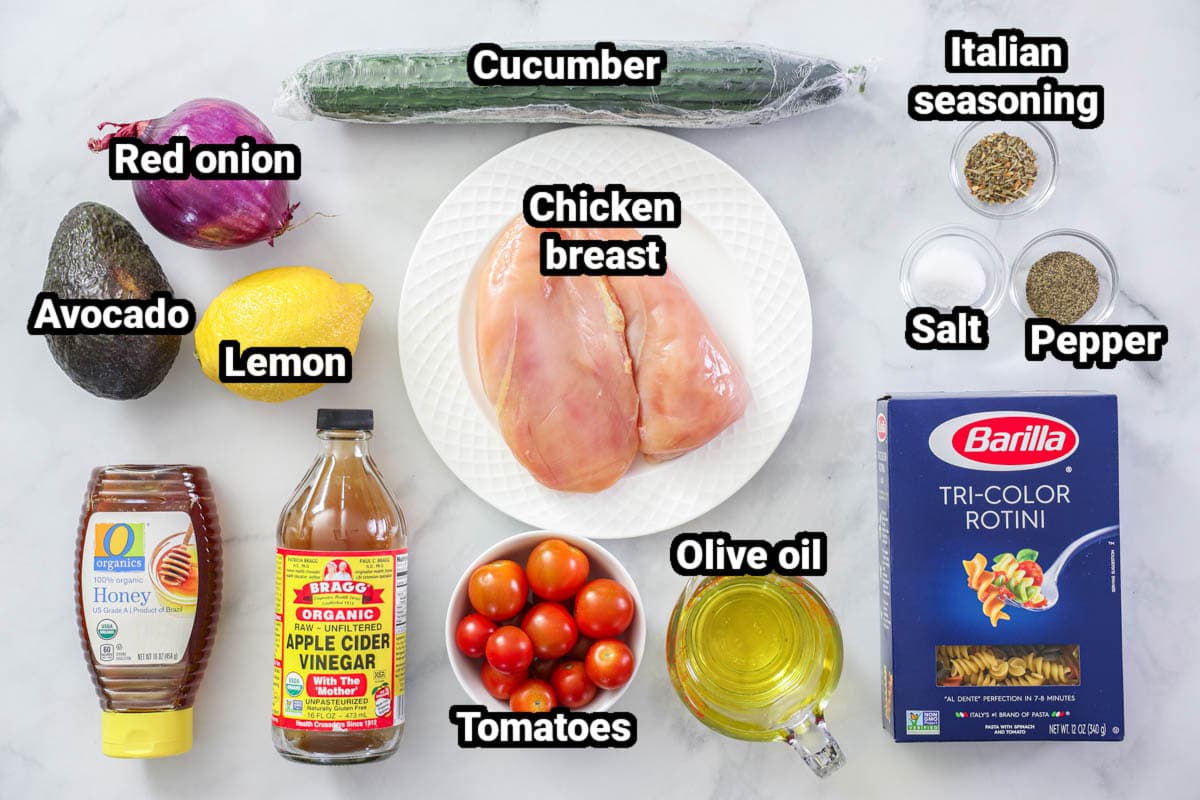 Ingredients for Chicken Pasta Salad: tricolor rotini, chicken breasts, Italian seasoning, salt, pepper, cucumber, olive oil, tomatoes, red onion, avocado, lemon, honey, and apple cider vinegar.
