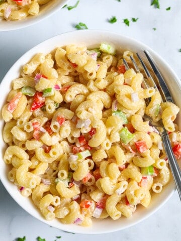 Creamy Pasta Salad with diced vegetables and elbow macaroni in a bowl with a fork.
