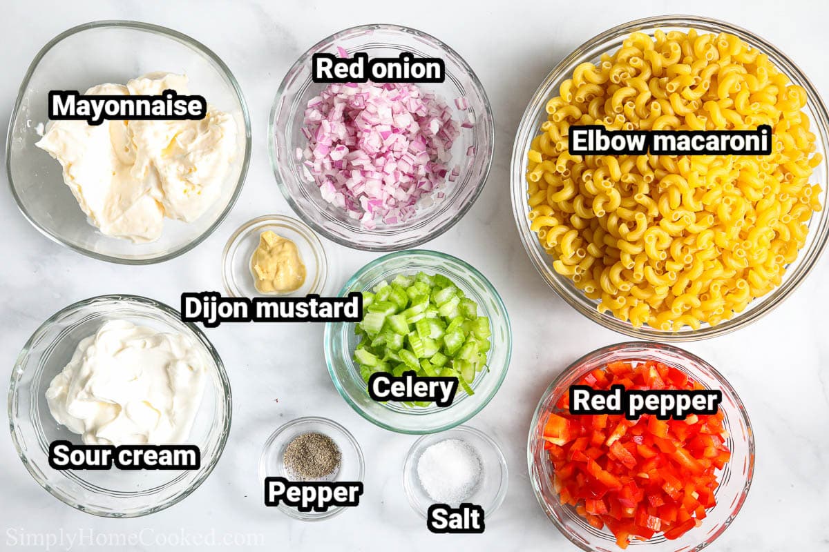 Ingredients for Creamy Pasta Salad: mayonnaise, sour cream, dijon mustard, celery, red onion, red pepper, elbow macaroni, salt, and black pepper.