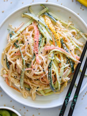 Vertical image of Kani Salad with chopsticks on the side of the plate.