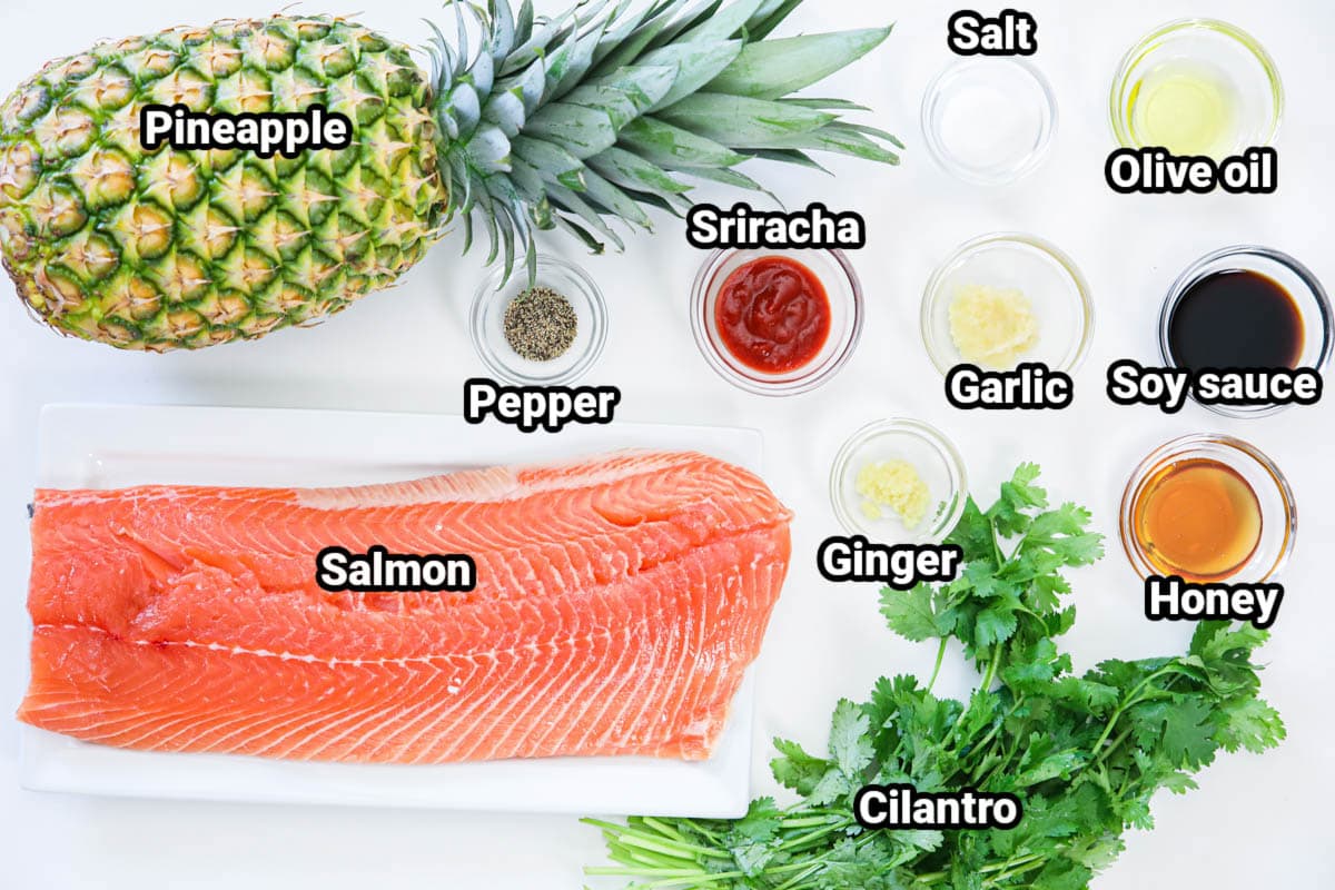 Ingredients for Grilled Honey Soy Salmon: pineapple, salmon, sriracha, salt, pepper, olive oil, garlic, ginger, honey, cilantro, and soy sauce.