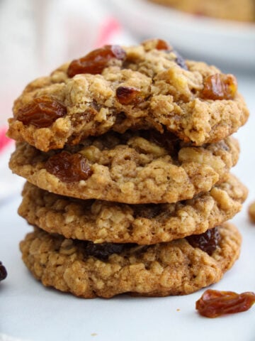 Pile of Oatmeal Raisin Cookies with one missing a bite.