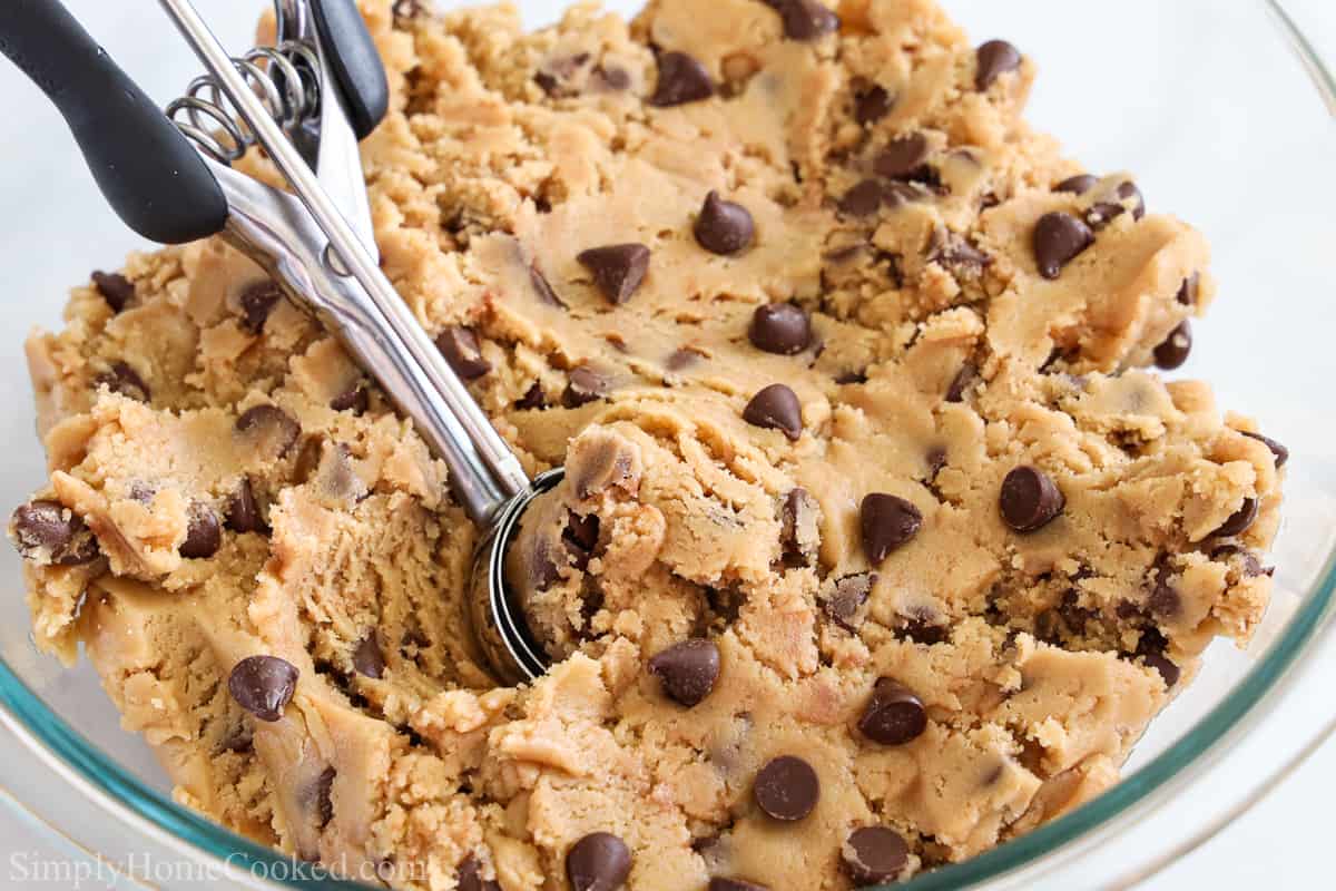 Bowl of Quick Edible Cookie Dough with a cookie scooper in it.