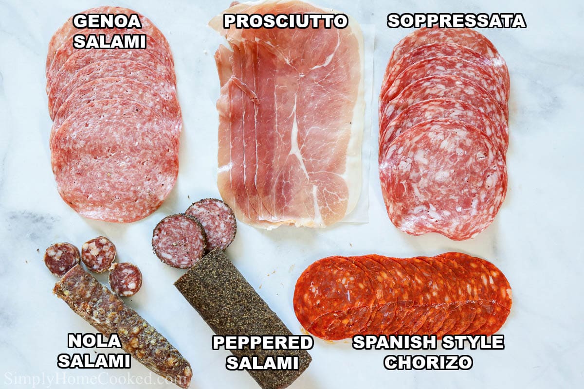Meats for an Ultimate Charcuterie Board: genoa salami, prosciutto, soppressata, Spanish style chorizo, peppered salami, and nola salami.