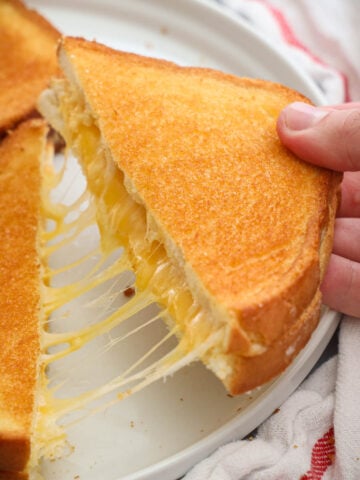 Air Fryer Grilled Cheese cut and being pulled apart