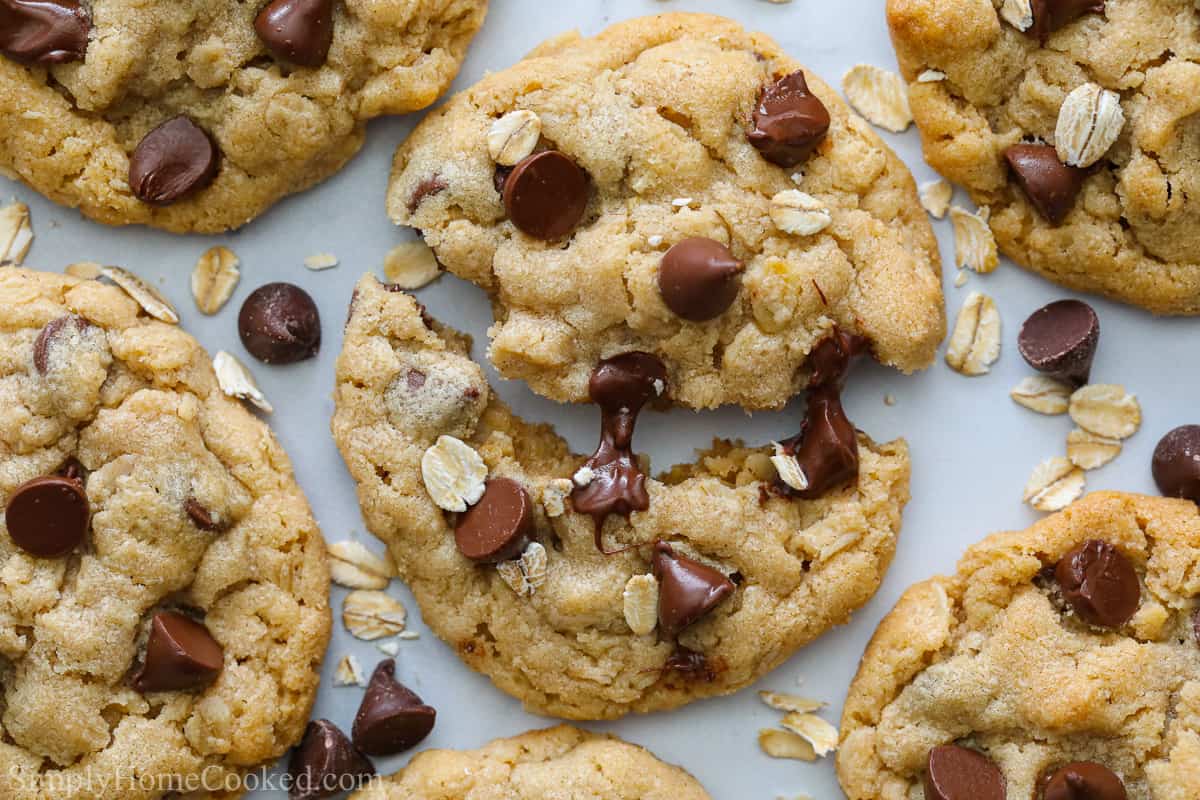 Chewy Peanut Butter Oatmeal Cookies with gooey chocolate chips, one cookie pulled apart.