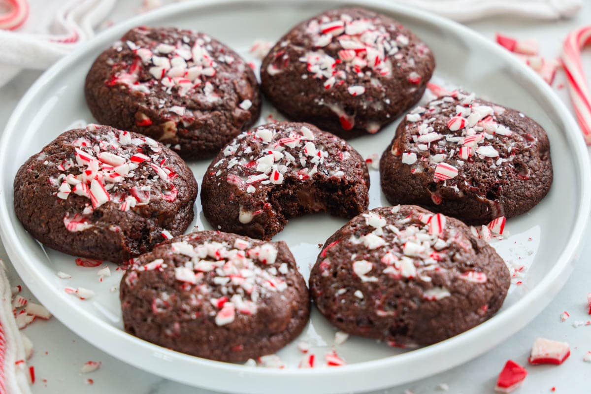 Chocolate Peppermint Cookies on a plate, one missing a bite.