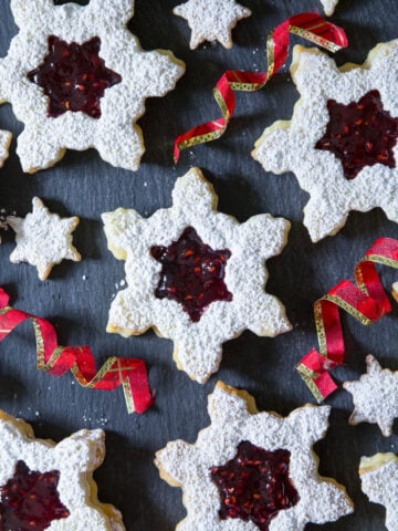 Linzer Cookies with Raspberry Jam alongside ribbons.