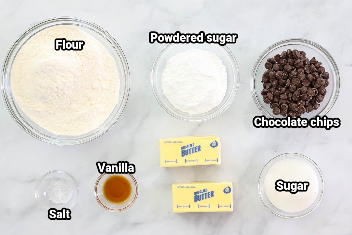 Ingredients for Classic Shortbread Cookies: flour, powdered sugar, chocolate chips, sugar, butter, vanilla, and salt.