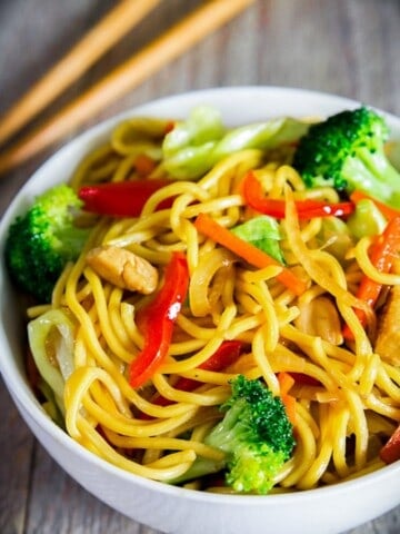 yakisoba noodles, broccoli, red bell pepper, and carrots in a bowl, chow mein