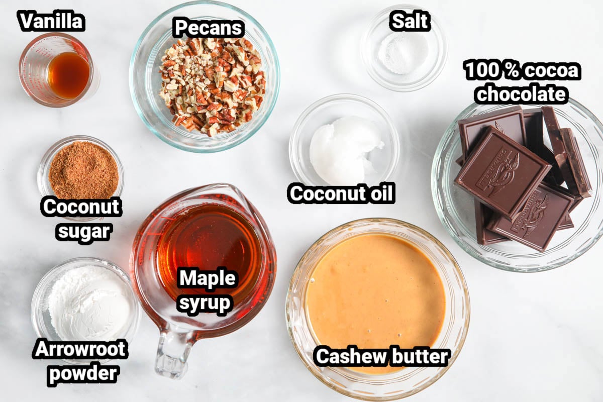 Ingredients for Paleo Chocolate Fudge: cocoa chocolate, salt, cashew butter, coconut oil, pecans, maple syrup, coconut sugar, arrowroot powder, and vanilla.