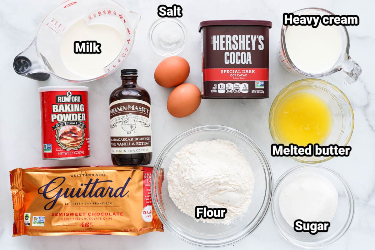 Ingredients for Chocolate Pancakes: milk, baking powder, vanilla, semisweet chocolate chips, eggs, salt, flour, cocoa powder, heavy cream, melted butter, and sugar.